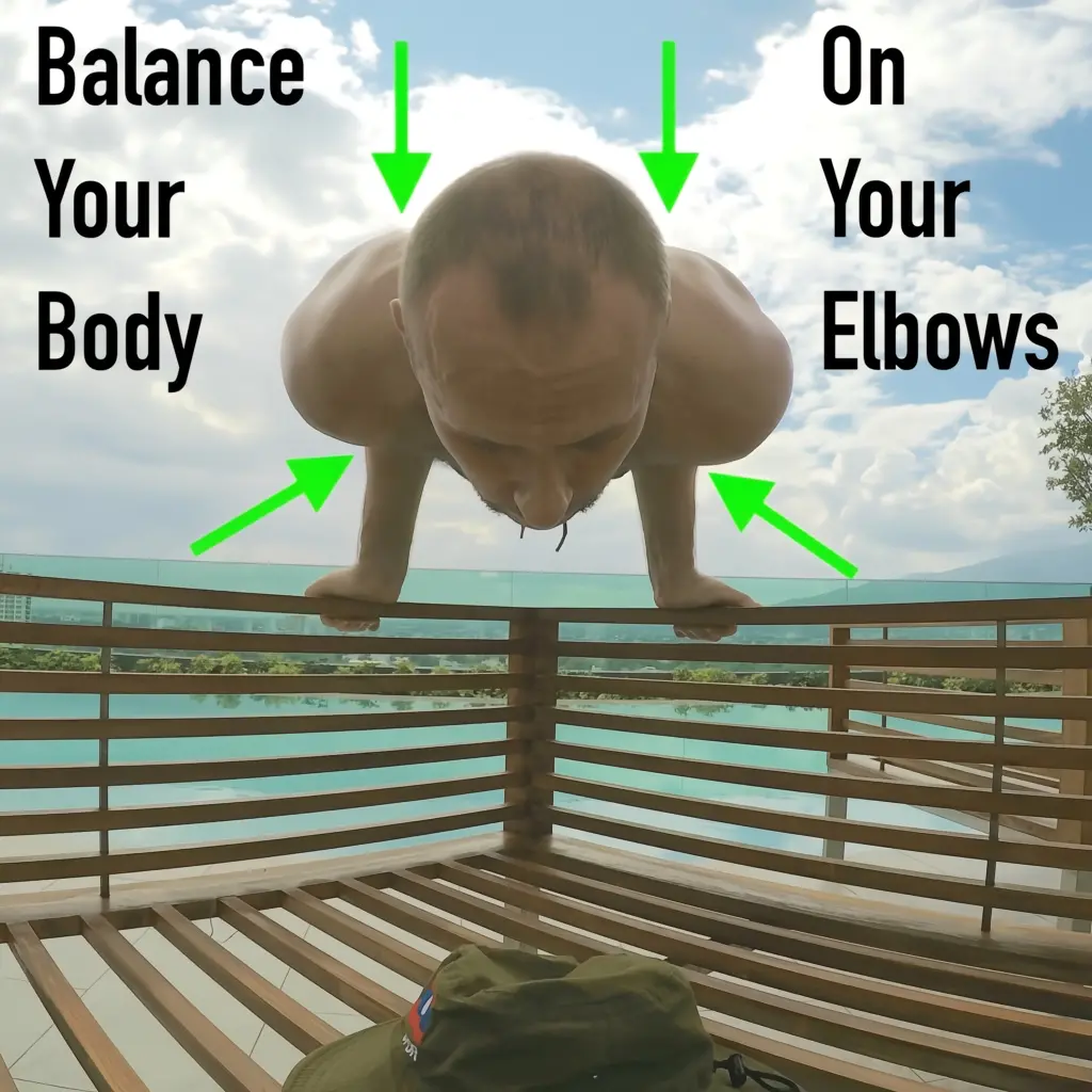 Demonstrating the balance elbow lever variation where the practitioner balances their bodyweight on their elbows