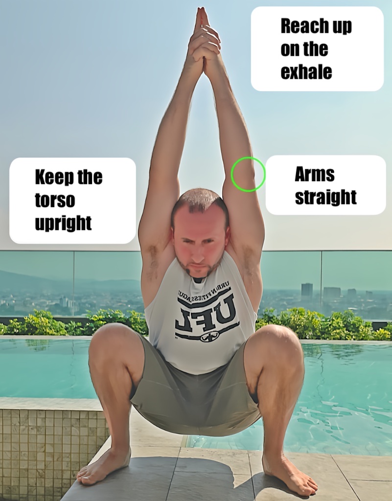 Deep squat variation with arms fully extended overhead