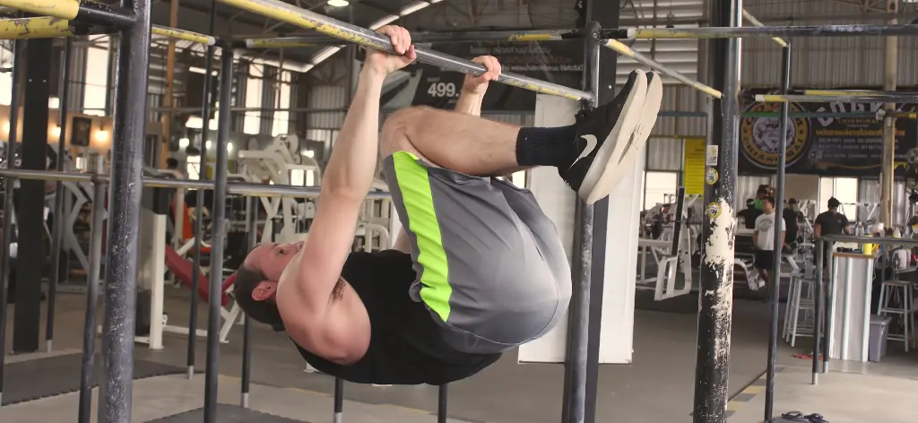 Tuck front lever on a pullup bar at an indoor gym