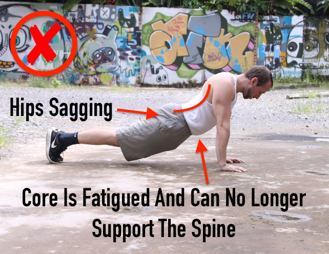 Demonstrating incorrect plank form, with hips sagging