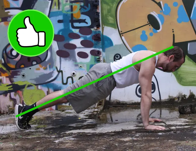 Demonstrating proper alignment with a neutral spine in the up portion of a pushup