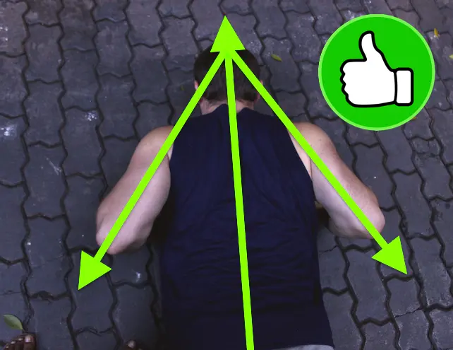Demonstrating correct arm alignment during a pushup. The image is from directly above the upper body and shows the arms at an angle, creating an arrow shape