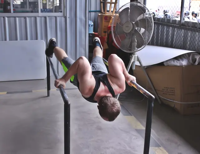 Deficit pushups on parallel bars - bottom position