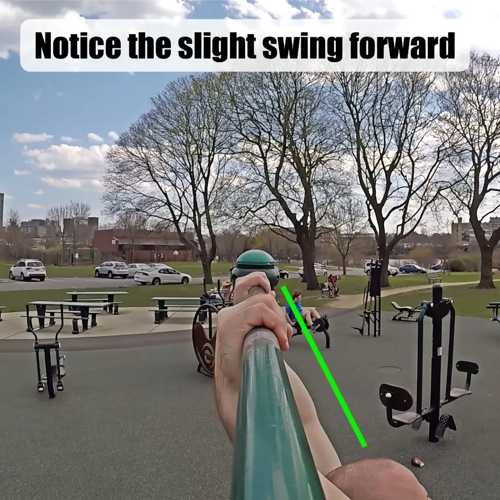 Demonstrating the first step in a bar muscleup, which is to slightly swing forward