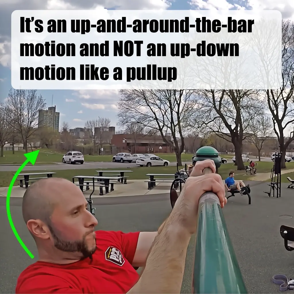 Demonstrating the up-and-around the bar movement of the bar muscleup