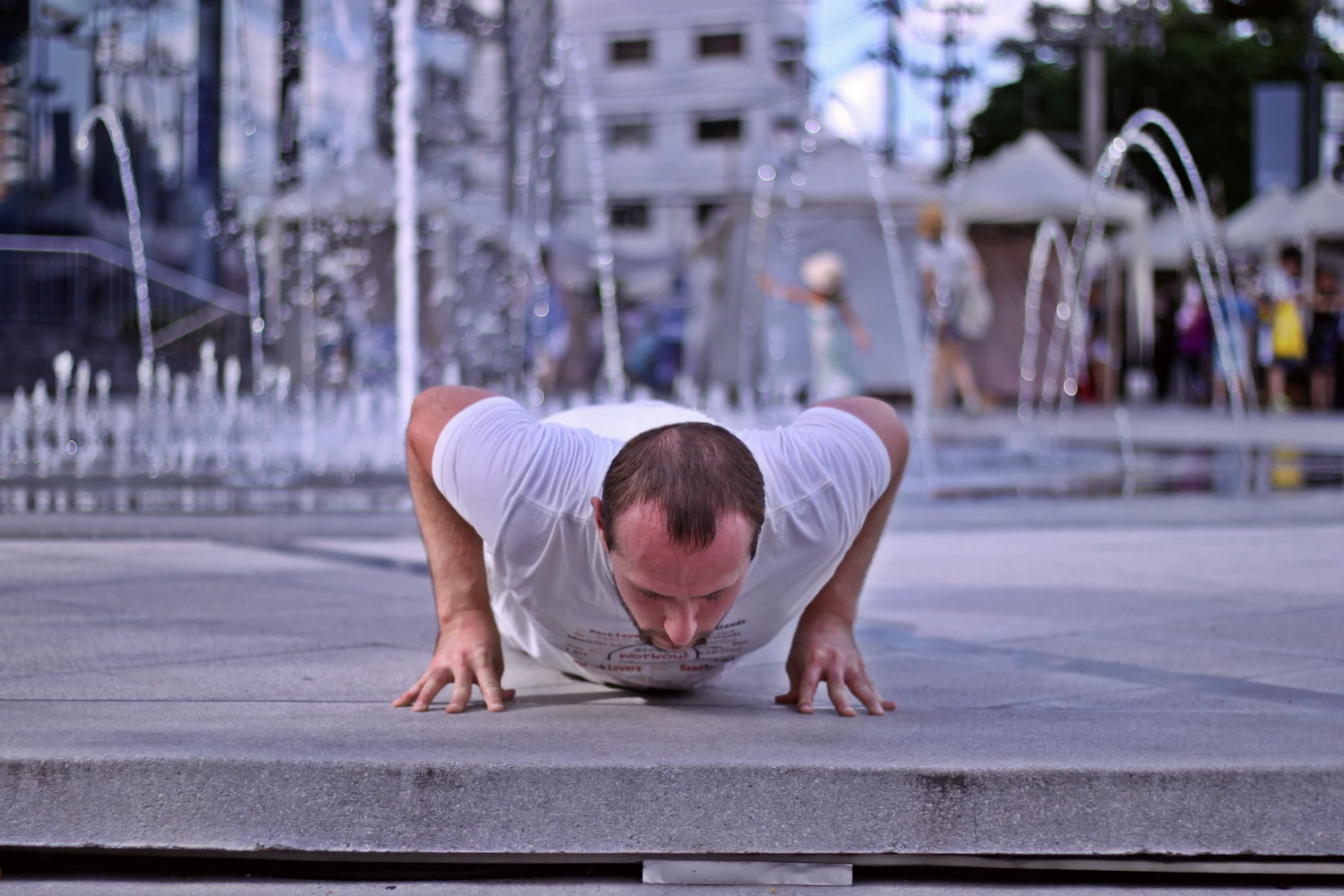 Demonstrating proper fingertip pushup form in the bottom of the range of motion