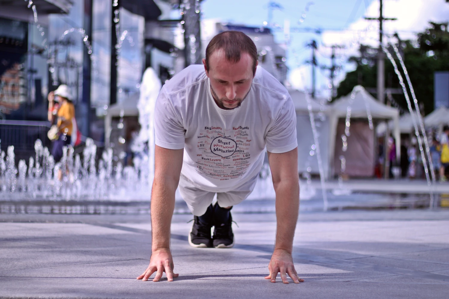 Demonstrating proper fingertip pushup form in the top of the range of motion