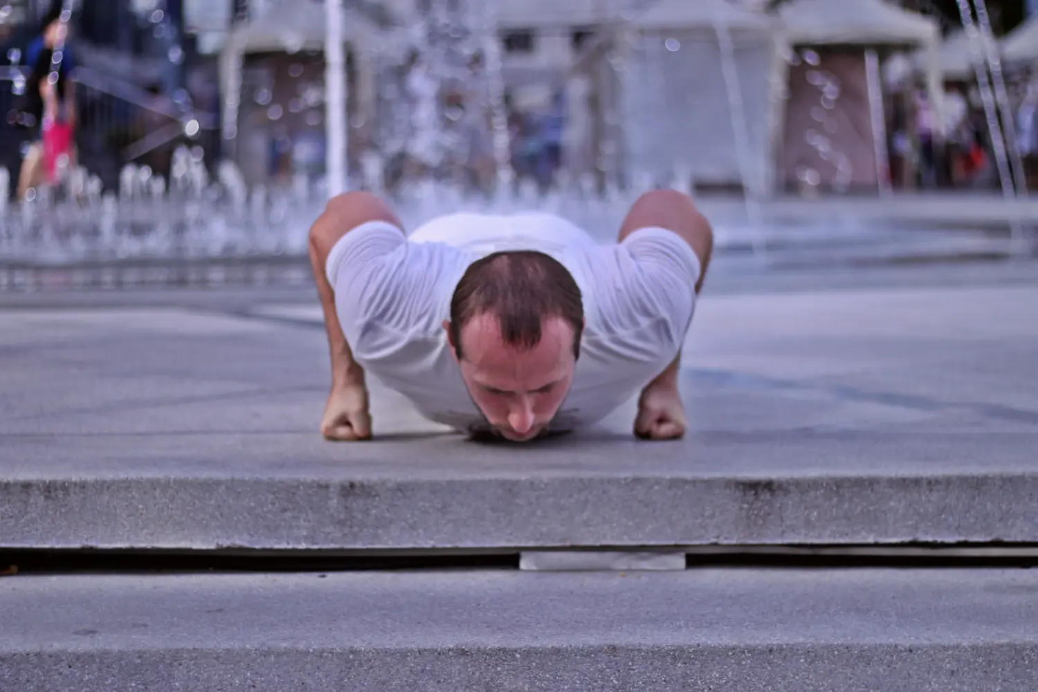 Demonstrating proper knuckle pushup form in the bottom of the range of motion