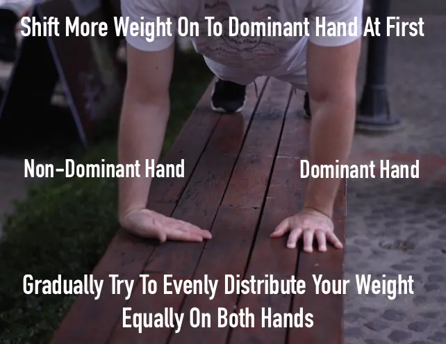 Demonstrating how to use one dominant hand and one non-dominant hand to gradually unlock wrist pushups