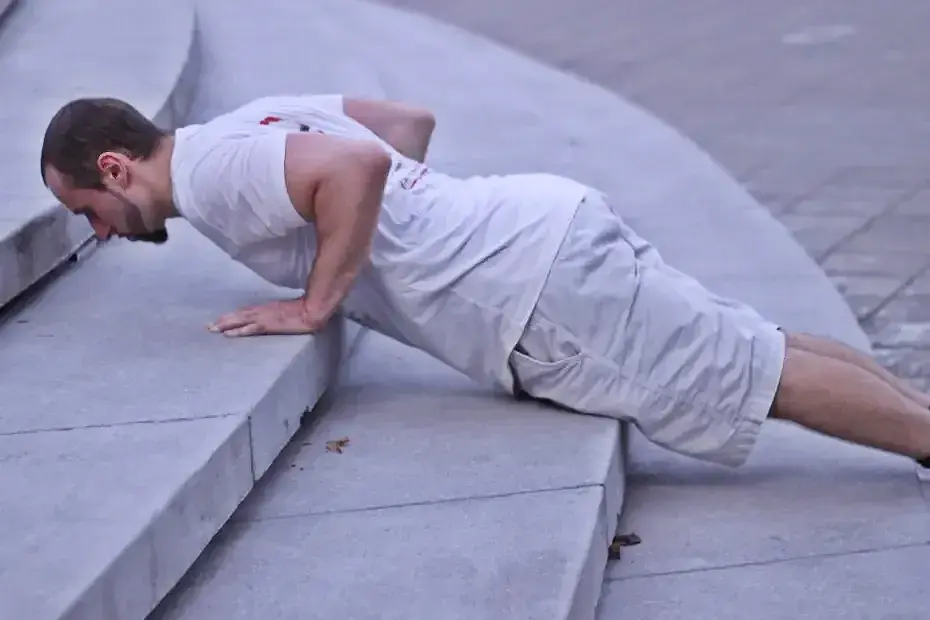Demonstrating the bottom portion of the rep in an elevated pushup