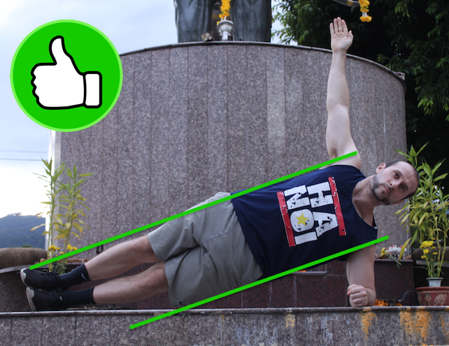 Demonstrating correct side plank form with bent support arm position