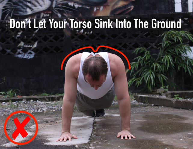 Showing incorrect plank form with torso sinking into the ground