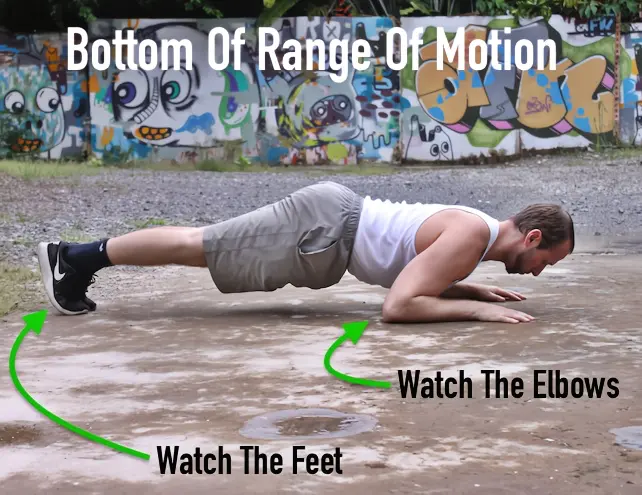 Bottom of the range of motion on a tiger bend pushup
