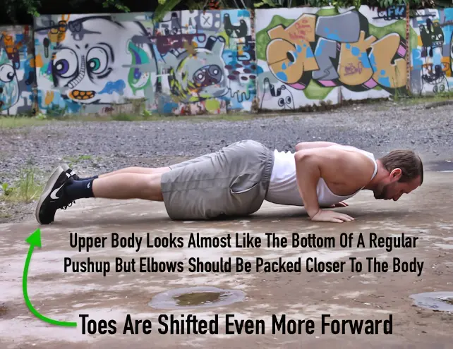 Tiger bend pushup transition with the elbows stacked above the wrists and heels forward past the toes