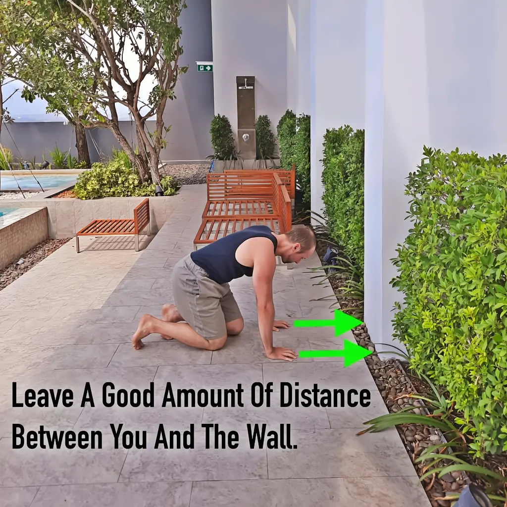 The starting position for the handstand toe taps drill, showing the approximate distance away from the wall.