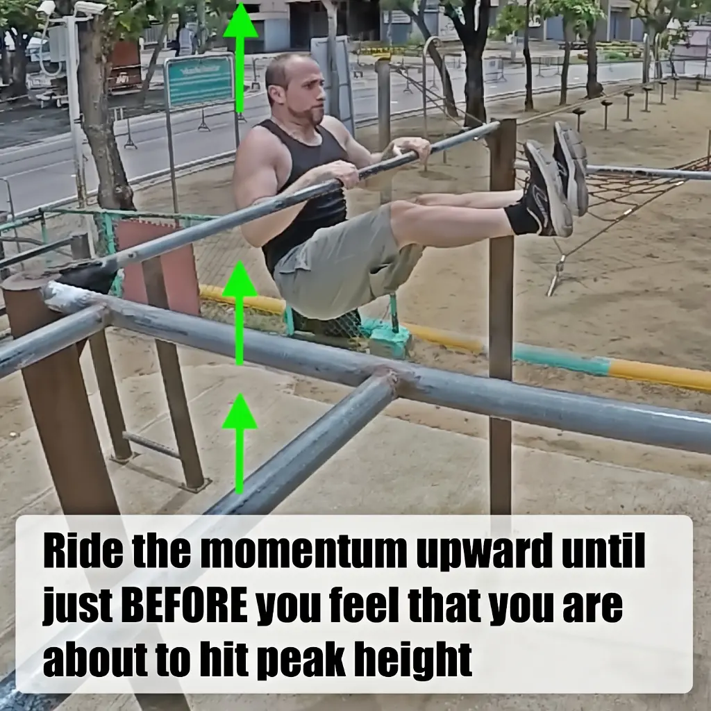 Highly elevated at this point with legs in an L-sit position and the body riding upward with hands still in contact with the bar